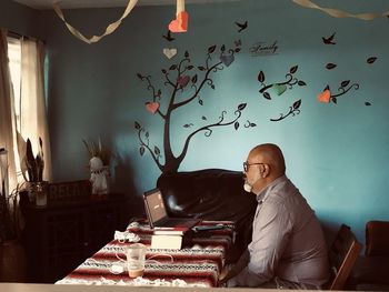 Man sitting on sofa at home