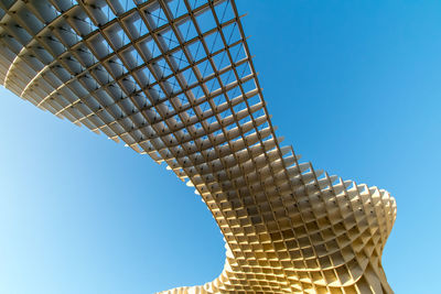 Low angle view of modern building against blue sky