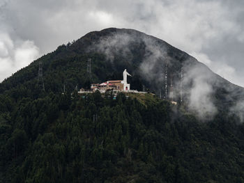 Scenic view of trees and mountains against sky