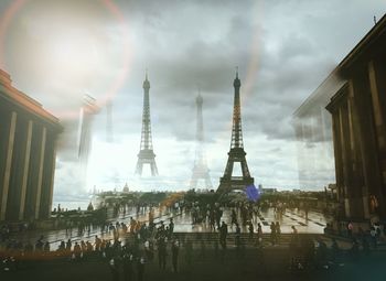 Digital composite image of eiffel tower and people in city
