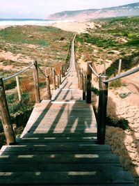 Footbridge leading towards sea