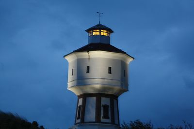 Low angle view of  watertower with light against sky