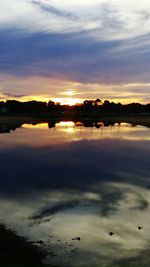 Scenic view of lake at sunset