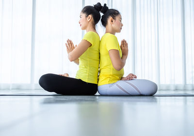 Side view of woman exercising at gym