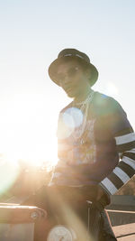 Portrait of young man standing against sky