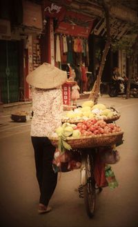 Midsection of woman eating food at market