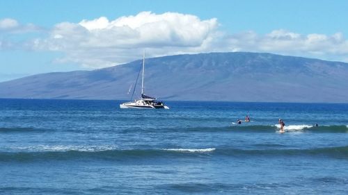 Boat sailing in sea against sky