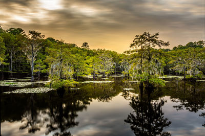 Scenic view of lake against sky at sunset