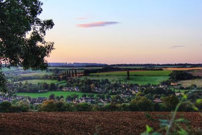 Scenic view of field against sky at sunset