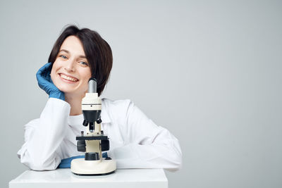 Portrait of a smiling young woman against white background