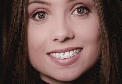 Close-up portrait of smiling young woman