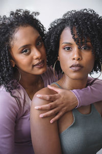 Portrait of two women of color hugging each other