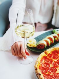 Midsection of man holding wineglass