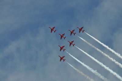 Low angle view of airshow against sky