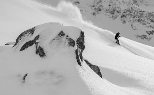 People skiing on snow covered land