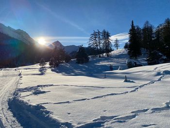 Snow covered landscape against sky