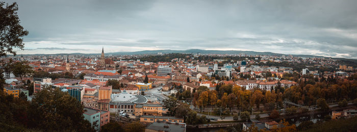 High angle view of houses in town against sky