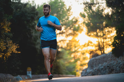 Full length portrait of young man running