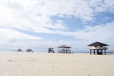 Lifeguard hut on beach against sky