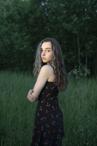 Portrait of woman standing on field