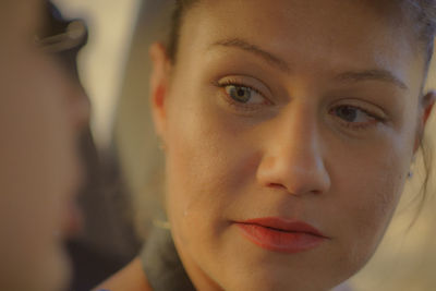 Close-up of young woman looking at friend