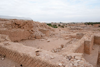 View of ruins of landscape against cloudy sky