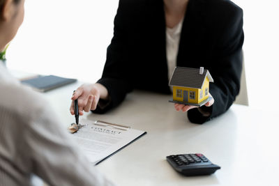 Midsection of business colleagues working on table