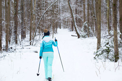 Rear view of person on snow covered land