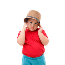 Portrait of cute girl standing against white background