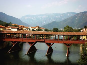 Scenic view of river by mountains against sky