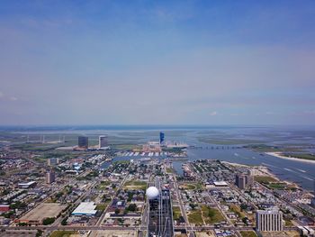 High angle view of town by sea against sky