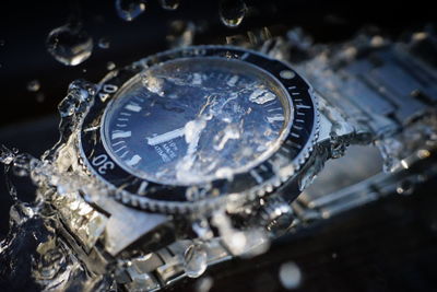 Close-up of water splashing on watch