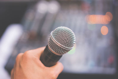 Close-up of hand holding microphone