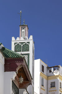 Low angle view of building against clear blue sky