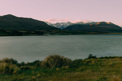 Scenic view of lake and mountains against sky