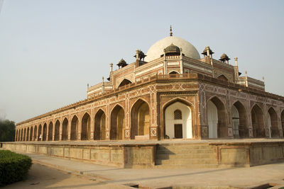 Facade of historic building against clear sky