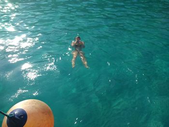 High angle view of man swimming in sea