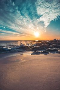 Scenic view of beach against sky during sunset