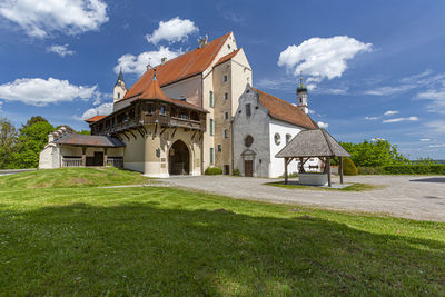 Building on field against sky