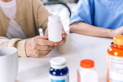 Midsection of woman holding medicine