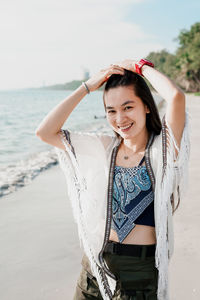 Young woman standing at beach