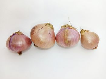 Close-up of fruits on table against white background