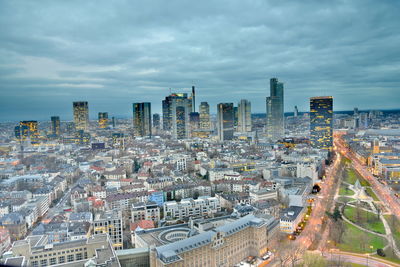 View of cityscape against cloudy sky