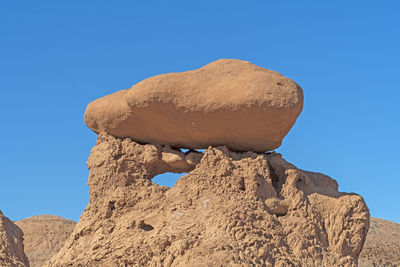 Eroded boulder on crumbling siltstone in goblin valley state park in utah