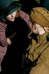 Midsection of woman wearing hat