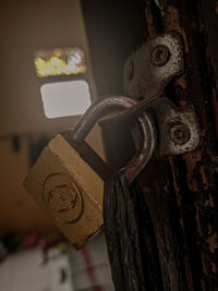 Close-up of old bell hanging on wood