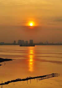 Scenic view of sea against orange sky