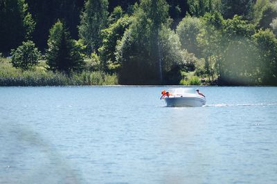 Father and son on boat over lake