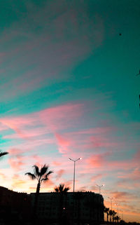 Low angle view of silhouette buildings against sky at sunset