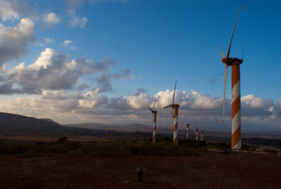 Windmill on field against sky